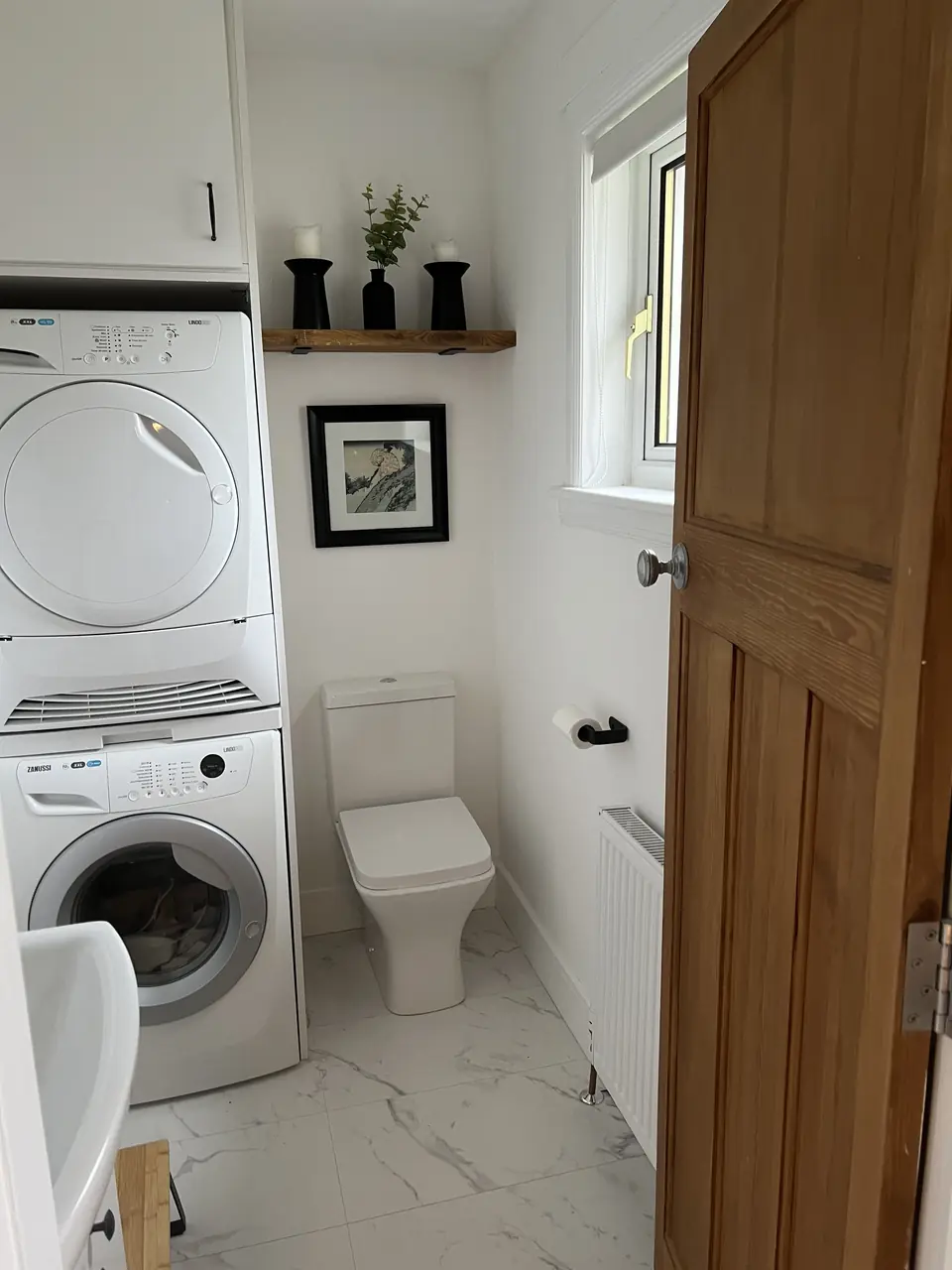 Cloakroom WC with stacked washing machine and dryer